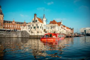 Explore Amsterdam cityscape with iconic canal and architectural charm.